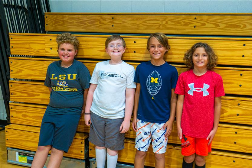 Students smile during an assembly